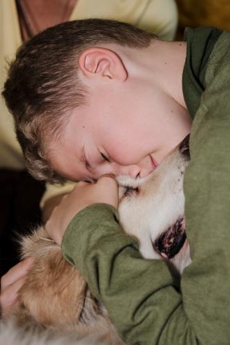 Boy lying down with dog